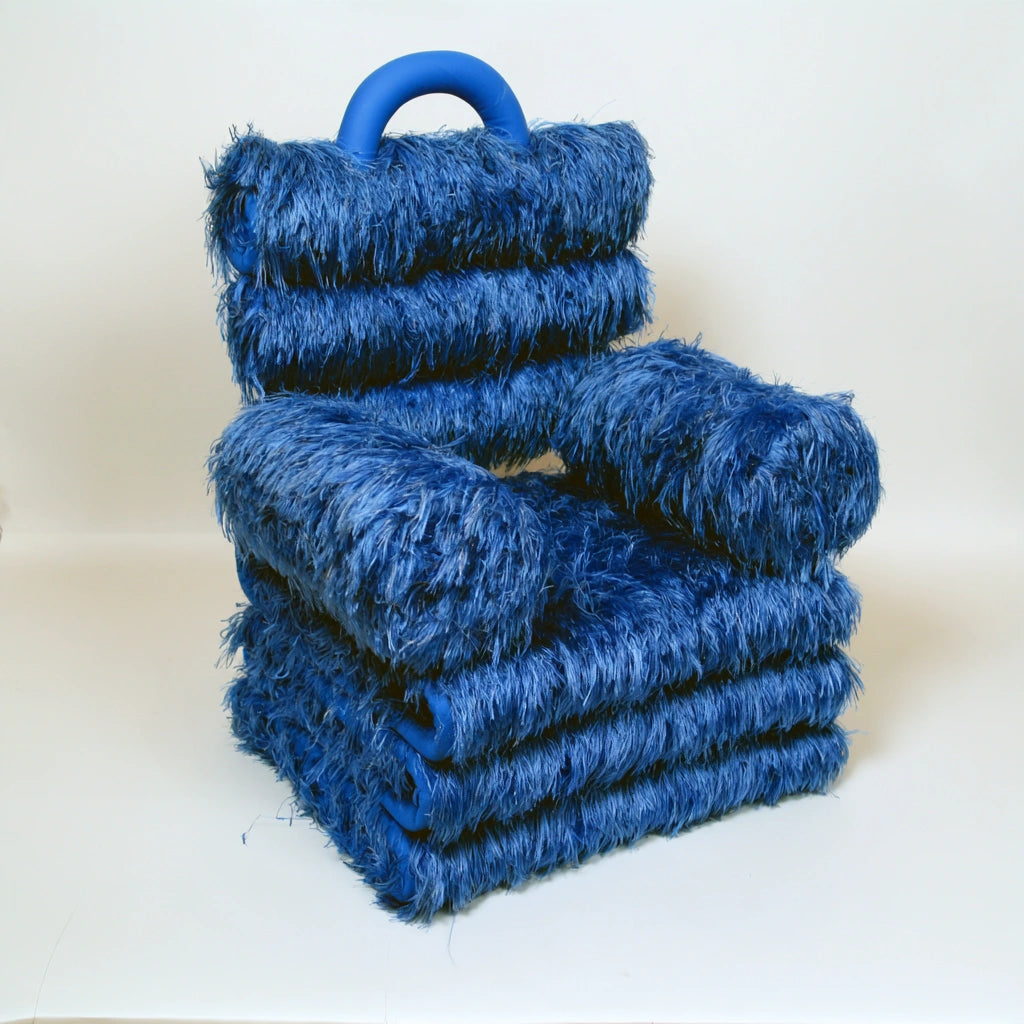 High-angle view of a dark blue, fluffy, convertible gestoffeerde stoel by mirrorandmist, showing its plush, cozy design.