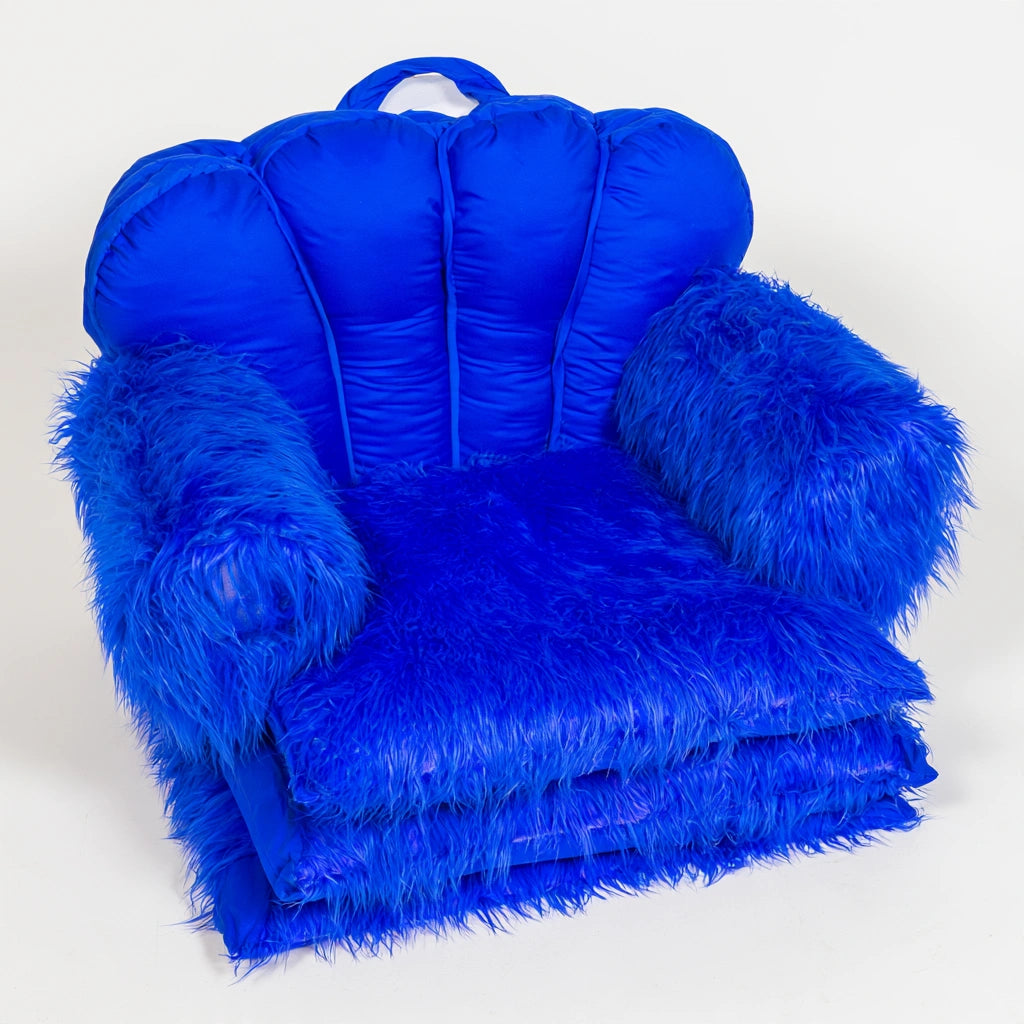 Deep blue fluffy upholstered convertible chair from mirrorandmist, shown from a high angle highlighting its plush texture and modern design.